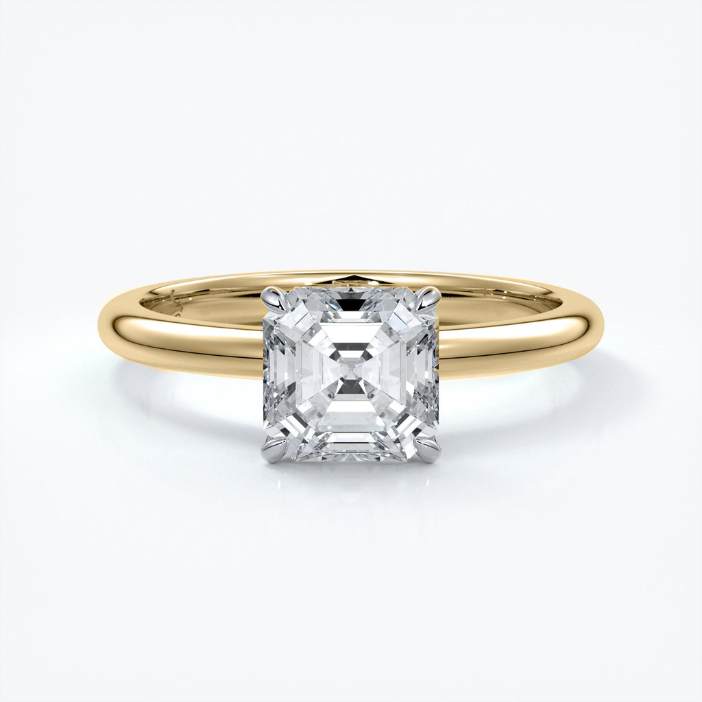 Gold ring with emerald cut diamond held by four claws
