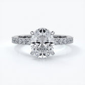 Platinum two carat oval diamond ring secured with four claws. Enhanced with a scalloped diamond band
