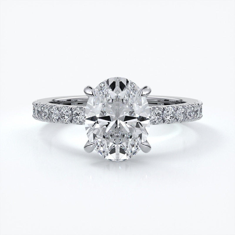 Platinum two carat oval diamond ring secured with four claws. Enhanced with a scalloped diamond band