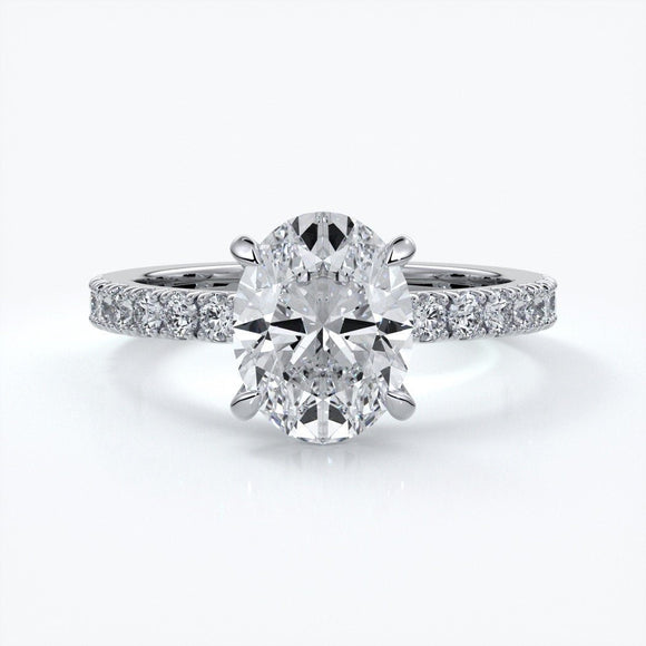 Platinum two carat oval diamond ring secured with four claws. Enhanced with a scalloped diamond band