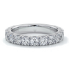 White gold women’s wedding ring with diamonds scalloped around the band.
