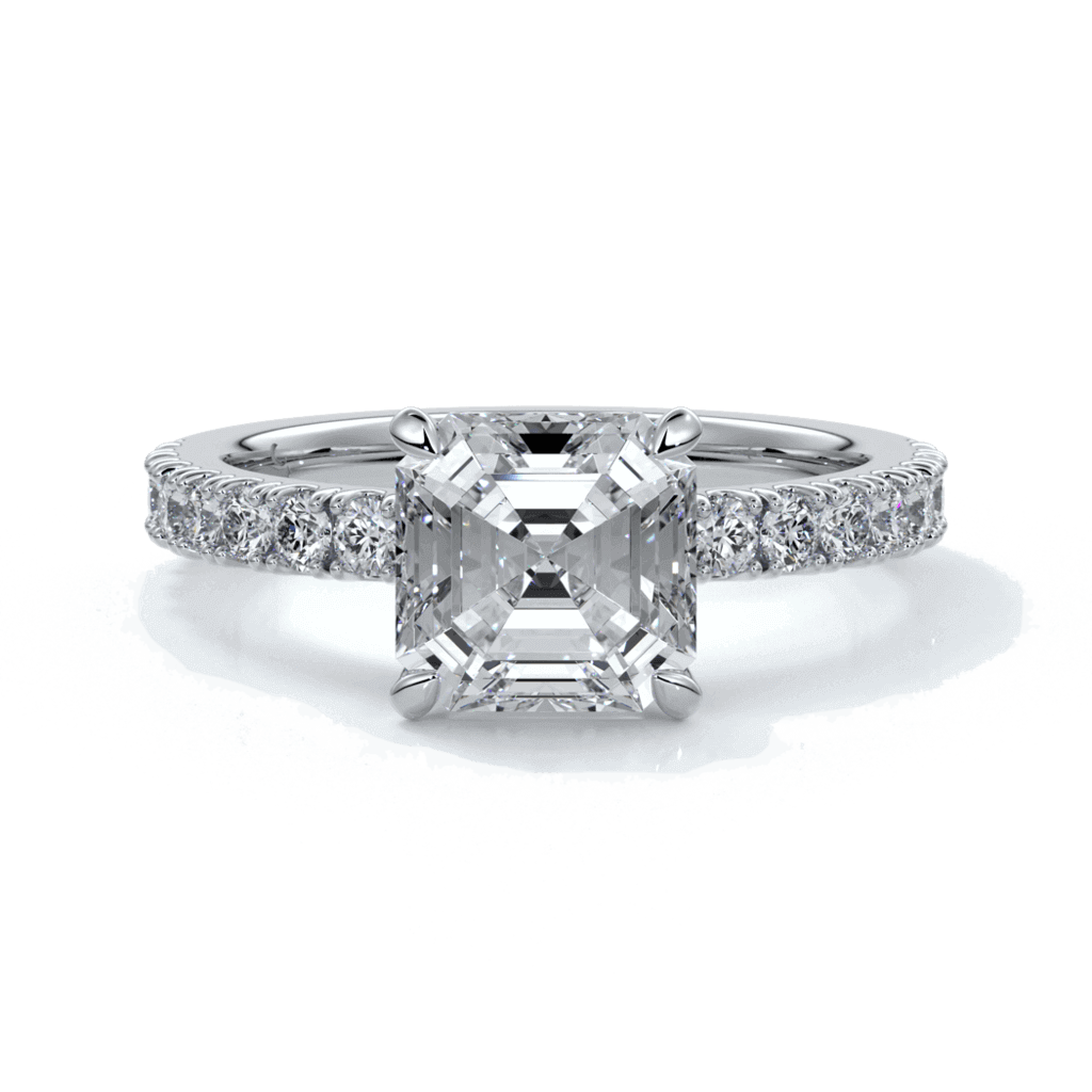 Platinum ring with square emerald diamond secured with four claws and enhanced with a scalloped diamond band