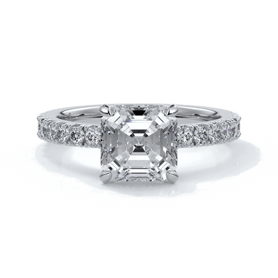 Platinum ring with square emerald diamond secured with four claws and enhanced with a scalloped diamond band