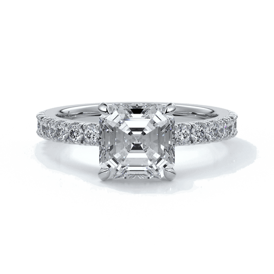 Platinum ring with square emerald diamond secured with four claws and enhanced with a scalloped diamond band