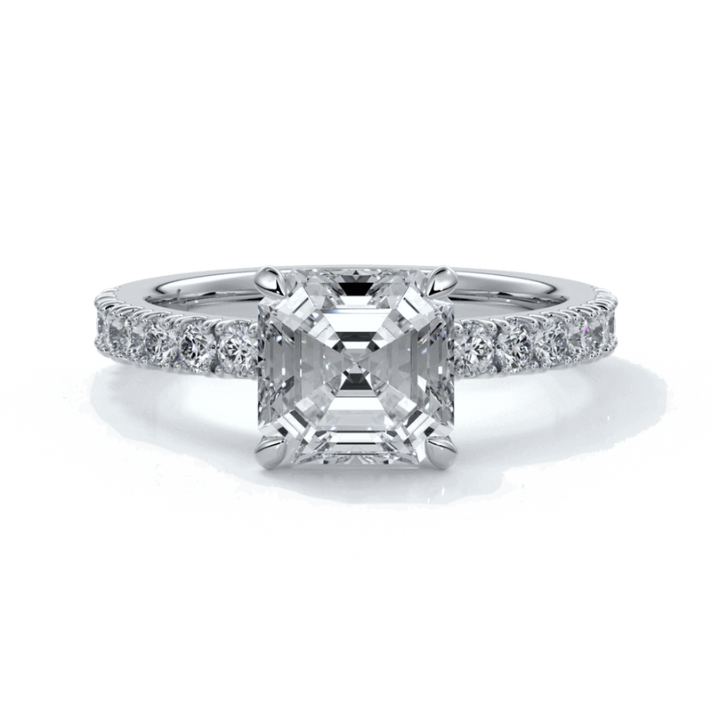 Platinum ring with square emerald diamond secured with four claws and enhanced with a scalloped diamond band