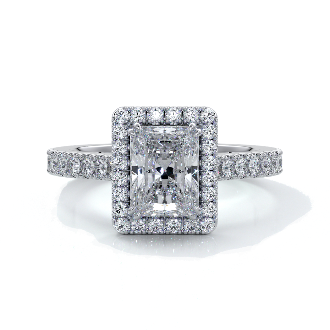 Platinum ring with a one point two carat, a radiant cut emerald diamond in a cathedral setting with a handset scalloped diamond band and halo