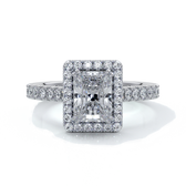 Platinum ring with a one point two carat, a radiant cut emerald diamond in a cathedral setting with a handset scalloped diamond band and halo