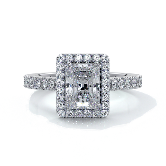 Platinum ring with a one point two carat, a radiant cut emerald diamond in a cathedral setting with a handset scalloped diamond band and halo