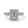 Platinum ring with a one point two carat, a radiant cut emerald diamond in a cathedral setting with a handset scalloped diamond band and halo