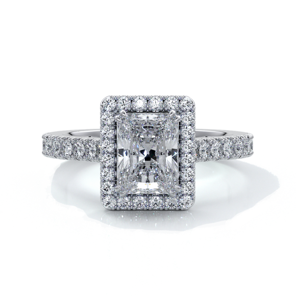 Platinum ring with a one point two carat, a radiant cut emerald diamond in a cathedral setting with a handset scalloped diamond band and halo