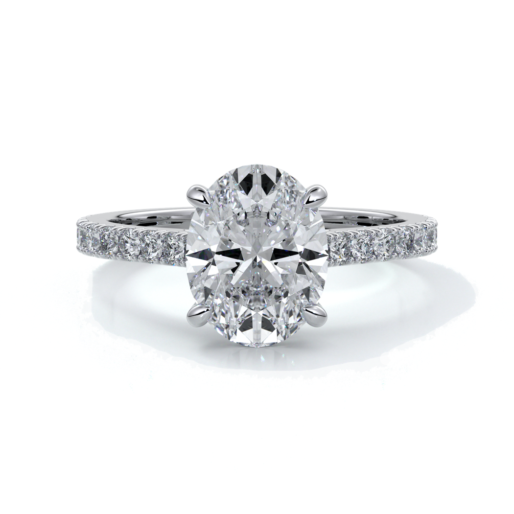 White gold ring with oval diamond secured with four claws with diamond on the shoulders