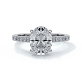 White gold ring with oval diamond secured with four claws with diamond on the shoulders