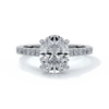 White gold ring with oval diamond secured with four claws with diamond on the shoulders