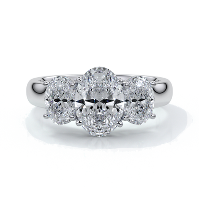 Platinum ring with oval trilogy diamond set with four claws with a cathedral setting
