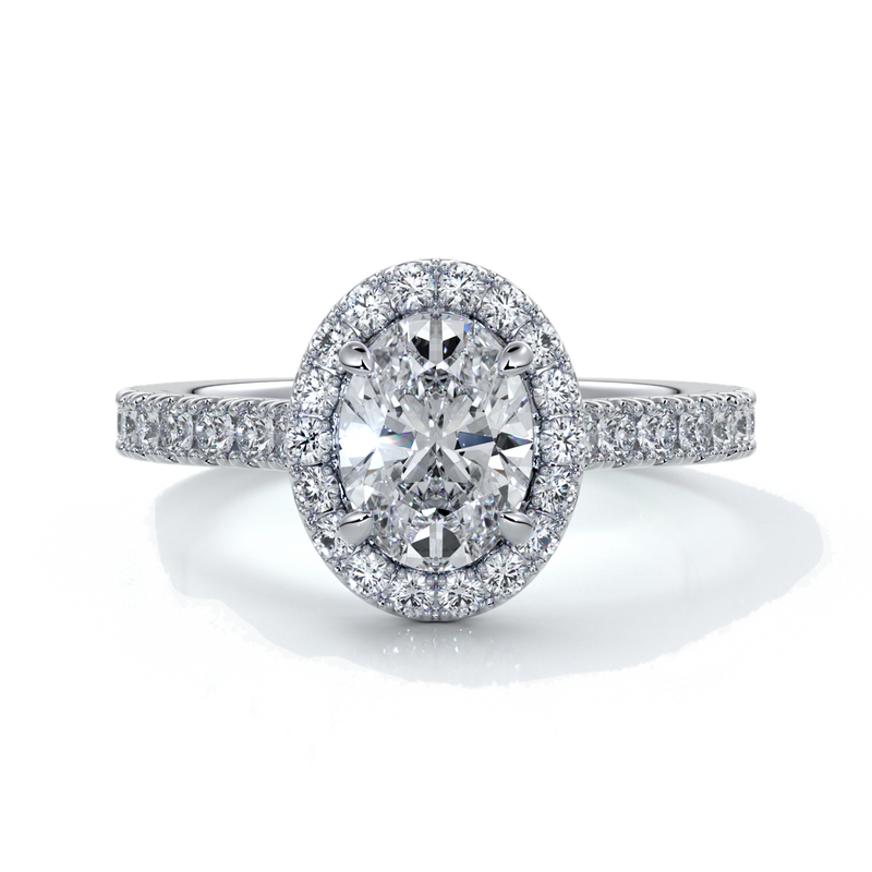 Platinum ring with one carat oval cut diamond in a cathedral style setting with scallop set shoulder diamonds and halo