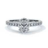 White gold ring with oval diamond secured with four claws and enhanced with cathedral setting with scalloped diamond band