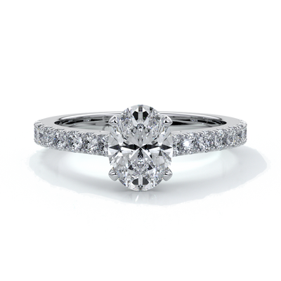 White gold ring with oval diamond secured with four claws and enhanced with cathedral setting with scalloped diamond band