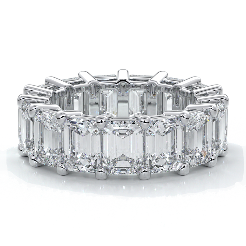 eighteen carat white gold women's wedding band with 5mm x 3.5mm Emerald cut diamonds in a scalloped setting
