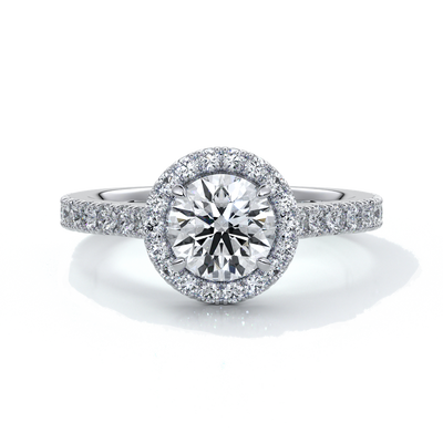 Platinum ring with a one and a half carat round diamond secured in four claws with a halo setting around the center diamond