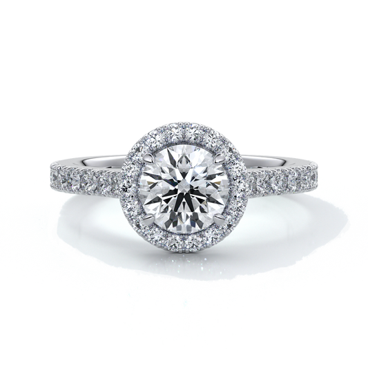 Platinum ring with a one and a half carat round diamond secured in four claws with a halo setting around the center diamond