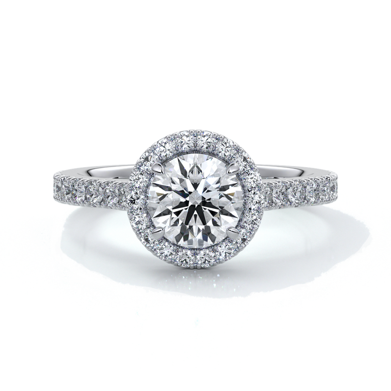Platinum ring with a one and a half carat round diamond secured in four claws with a halo setting around the center diamond