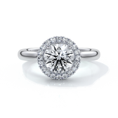 one carat round cut diamond with halo enhanced in a cathedral setting. Set in platinum