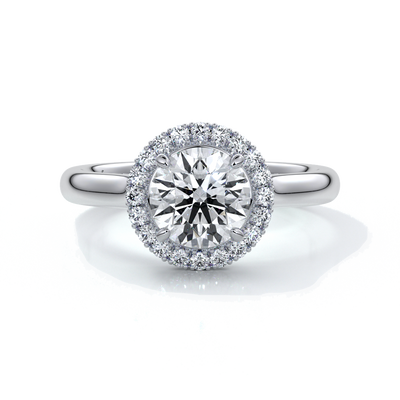 one carat round cut diamond with halo enhanced in a cathedral setting. Set in platinum