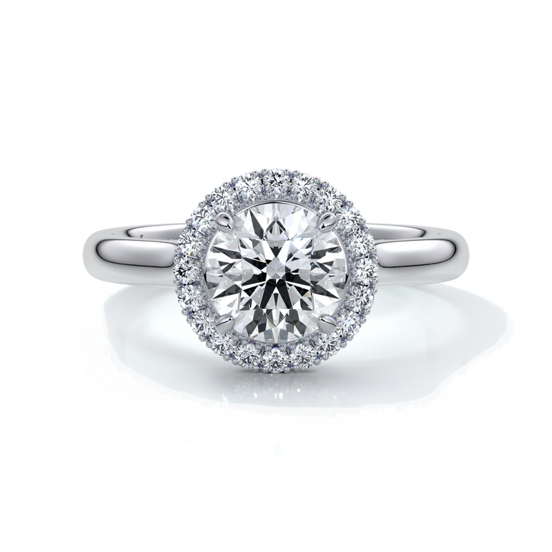 one carat round cut diamond with halo enhanced in a cathedral setting. Set in platinum