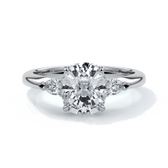 Platinum ring with a cushion cut center diamond and pear diamonds enhancing the trilogy