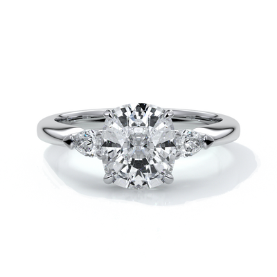 Platinum ring with a cushion cut center diamond and pear diamonds enhancing the trilogy