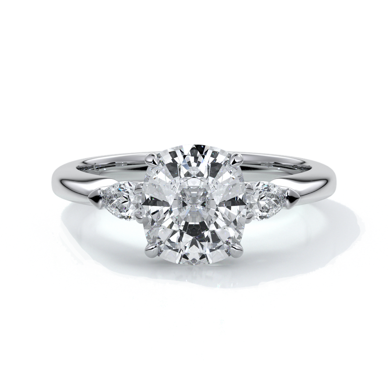 Platinum ring with a cushion cut center diamond and pear diamonds enhancing the trilogy
