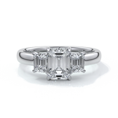 Platinum eighteen carat Stalla emerald cut trilogy diamond ring, with cathedral setting