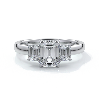 Platinum eighteen carat Stalla emerald cut trilogy diamond ring, with cathedral setting