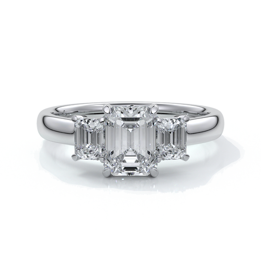 Platinum eighteen carat Stalla emerald cut trilogy diamond ring, with cathedral setting