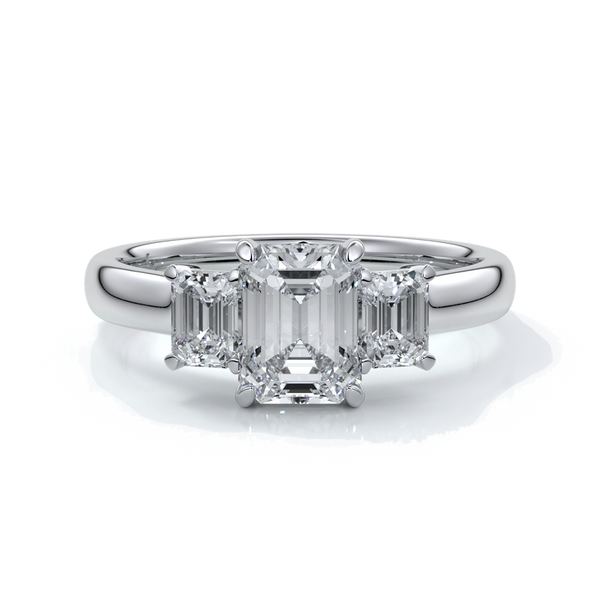 Platinum eighteen carat Stalla emerald cut trilogy diamond ring, with cathedral setting