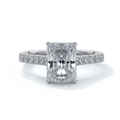 Ring with radiant cut diamond enhanced in a cathedral setting with a scalloped diamond band, cast in platinum