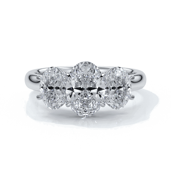 Engagement ring with a straight trilogy of oval diamonds set in platinum