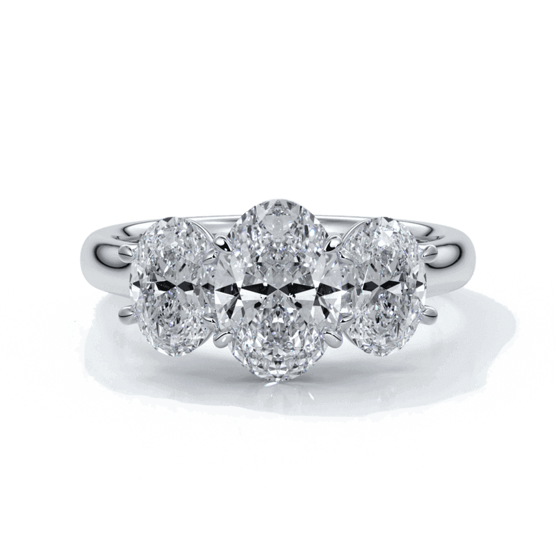 Engagement ring with a straight trilogy of oval diamonds set in platinum